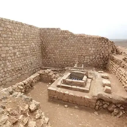 Ancient stone ruins in arid landscape.